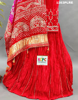 A red and pink silk lehenga with bandhani style 