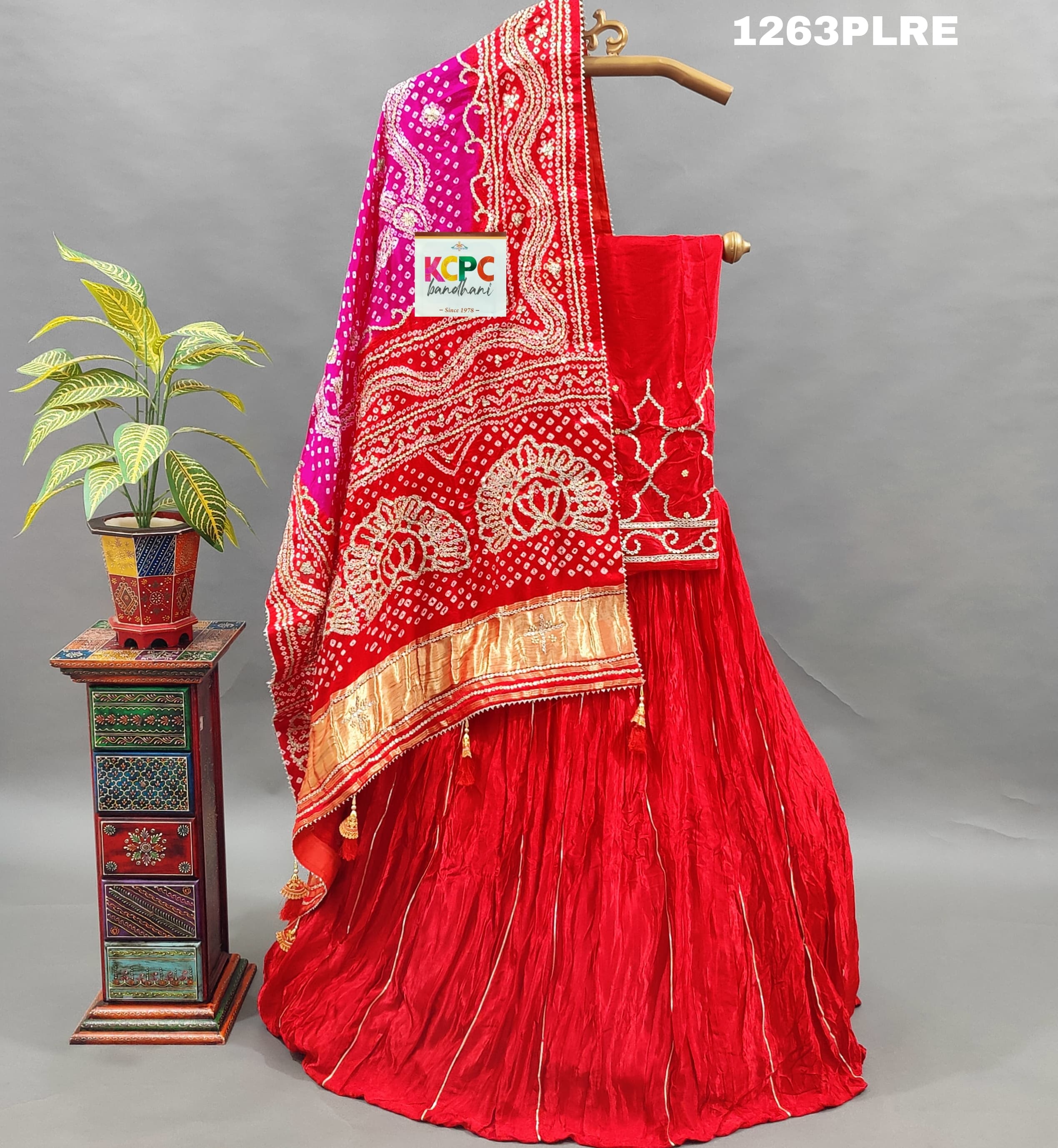 A red and pink silk lehenga with bandhani style 