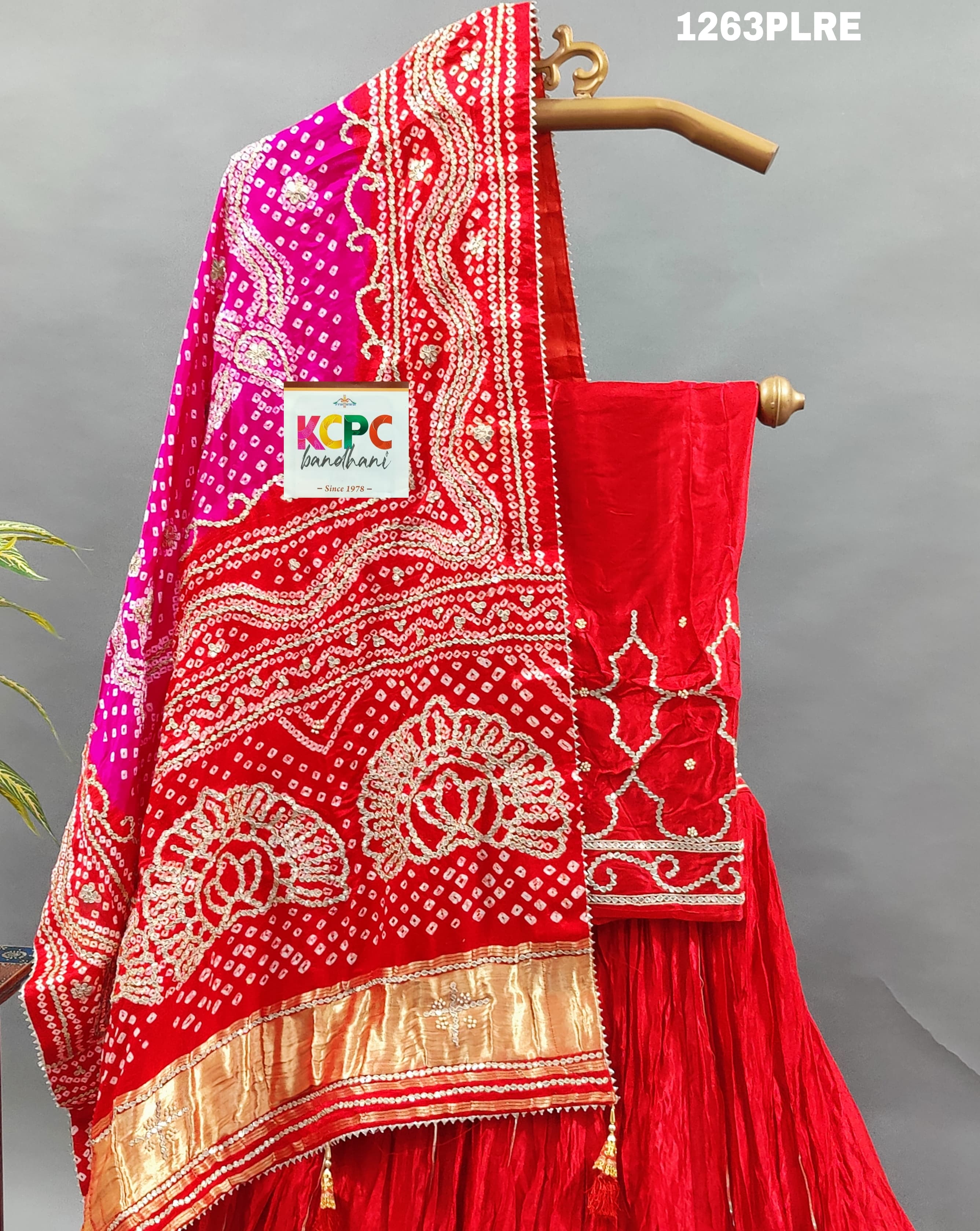 A red and pink silk lehenga with bandhani style 