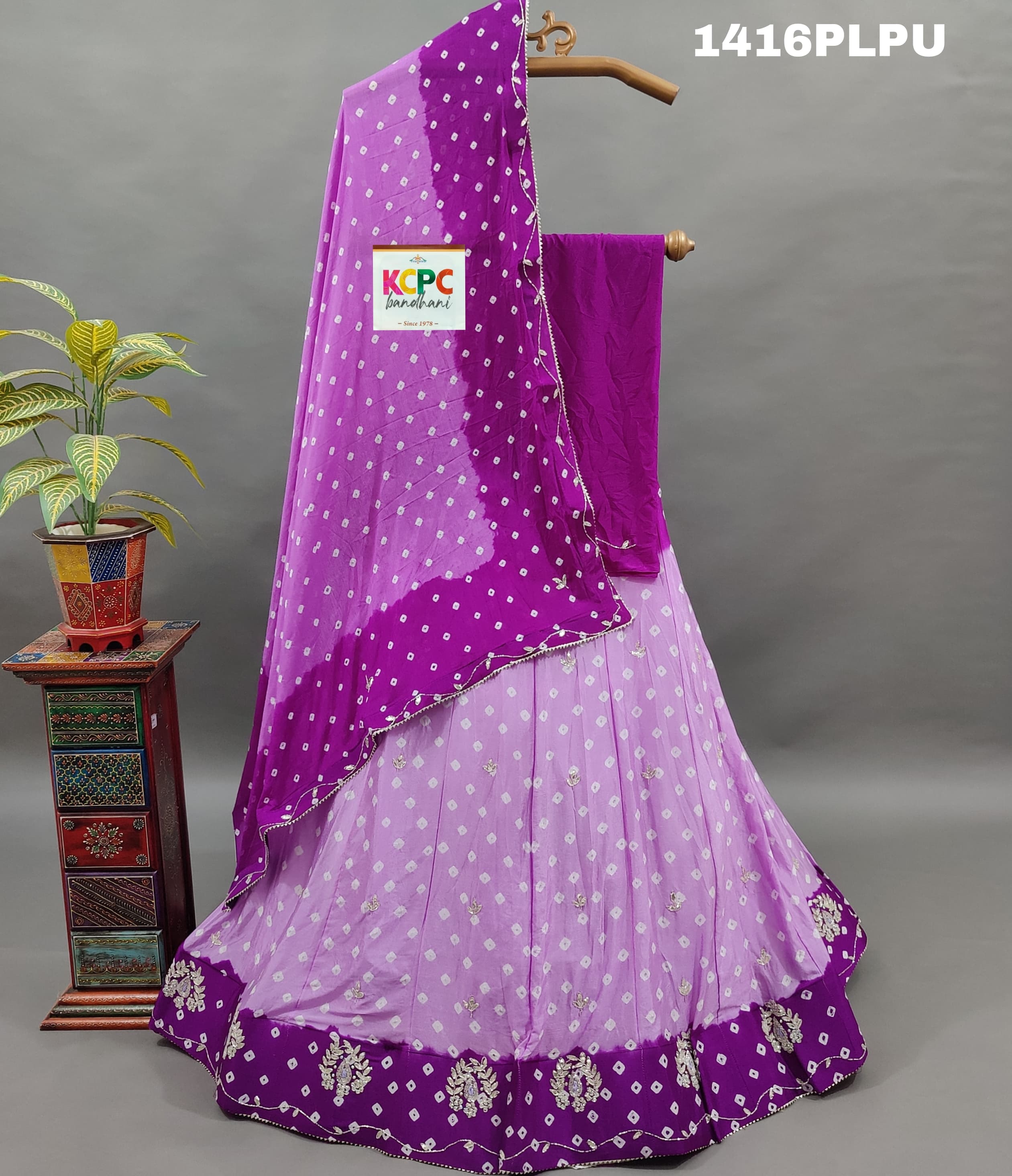 A purple lehenga with double shade bandhani cutdana work