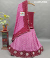 A traditional Indian lehenga set with pink and purple colors