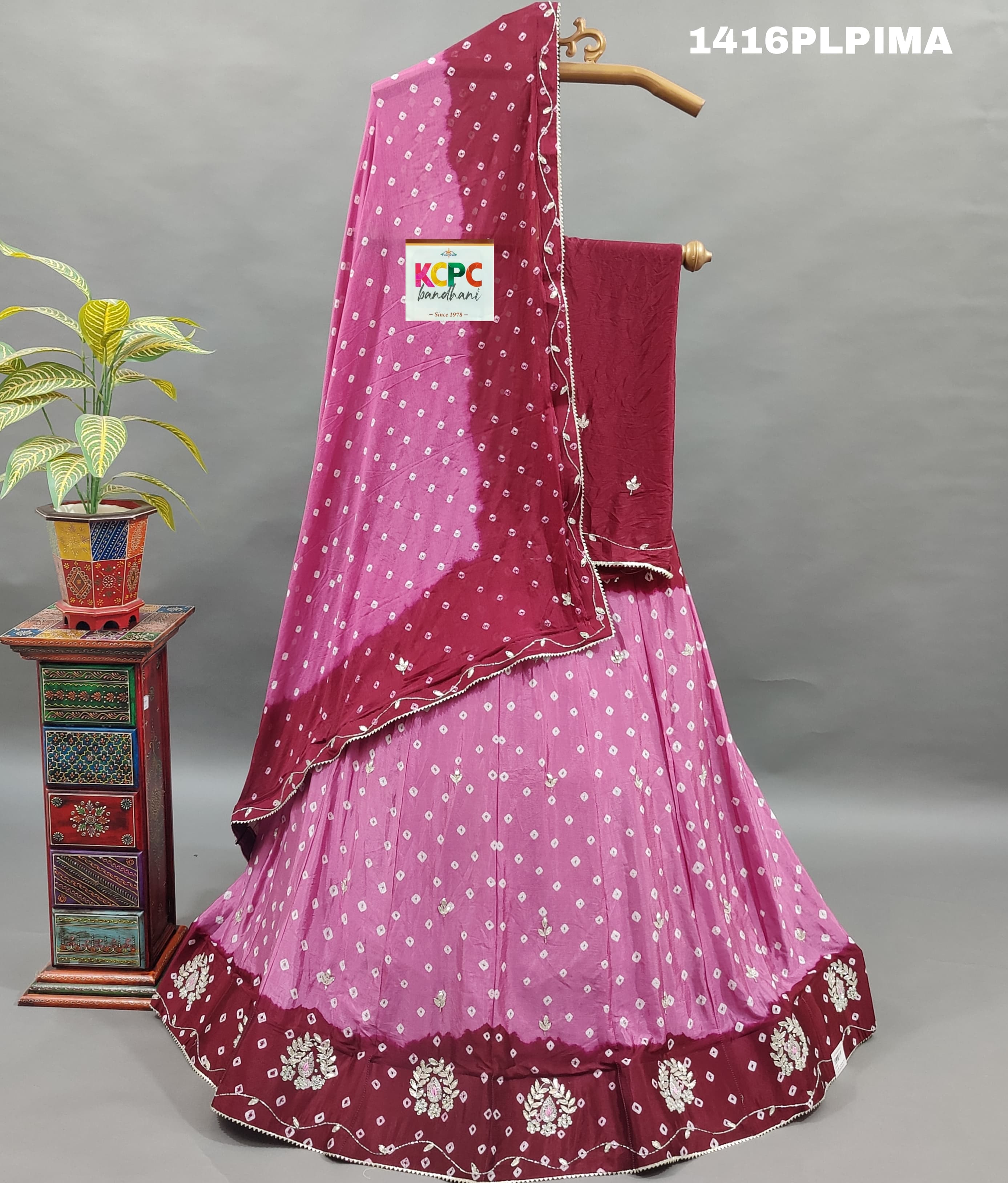 A traditional Indian lehenga set with pink and purple colors