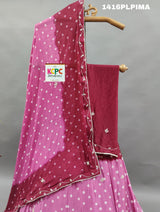 A traditional Indian lehenga set with pink and purple colors