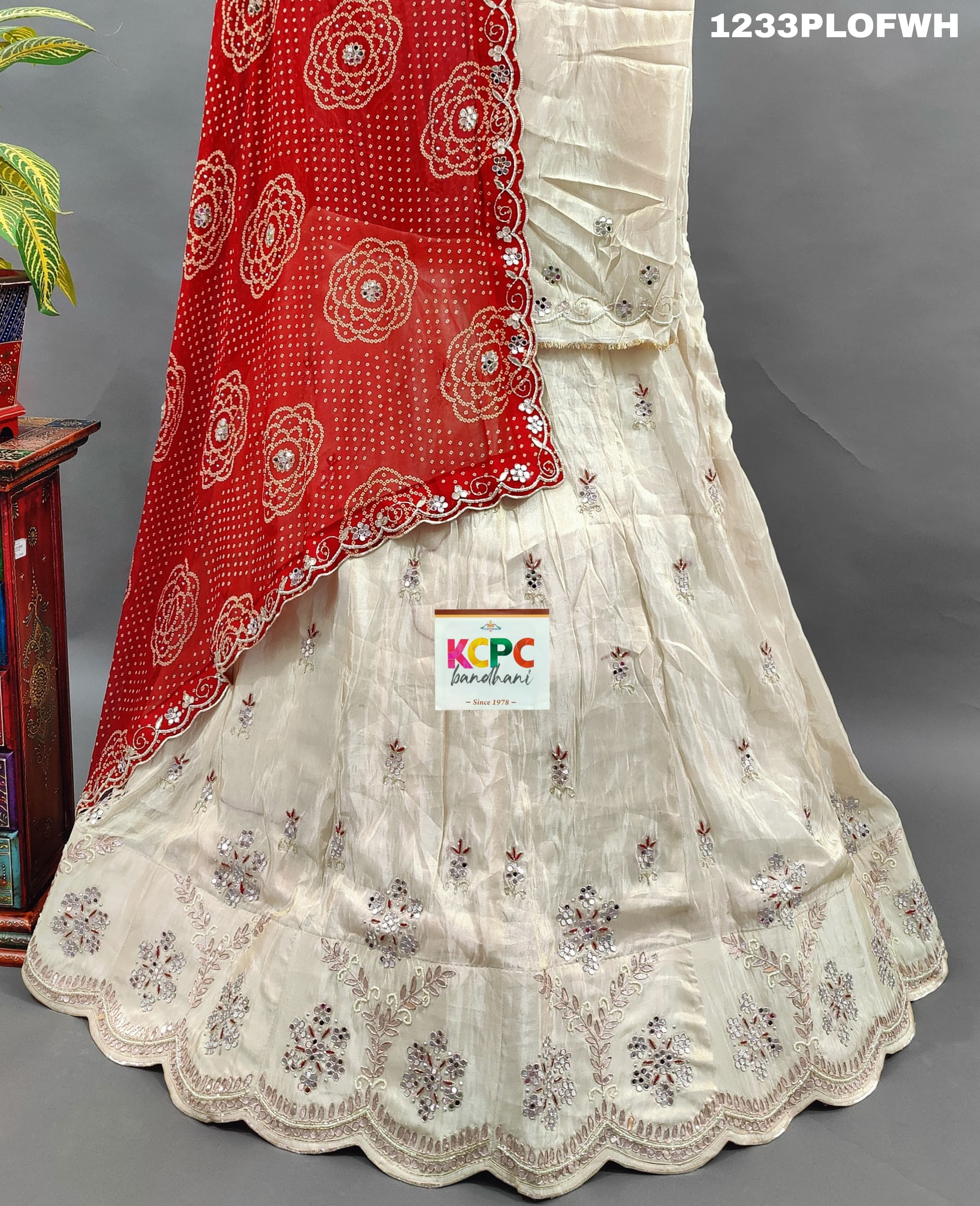 A red and white traditional lehenga withmirror work