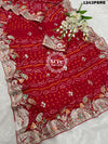 A red bandhani saree with gota patti work