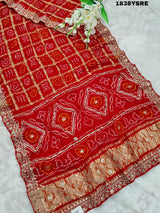 A red and gold saree with floral patterns and gota patti embellishments