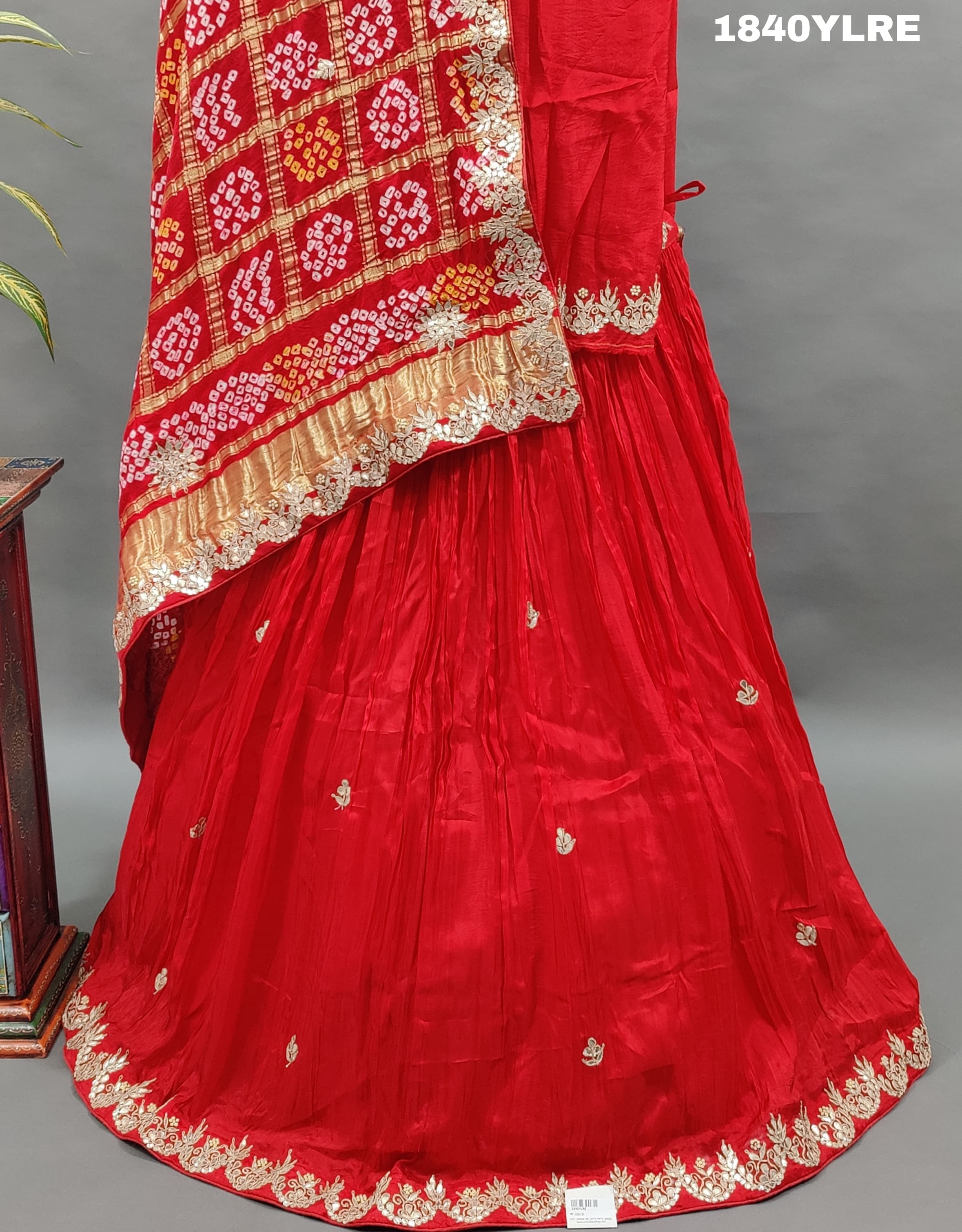 A red pure gaji silk lehenga with bandhani gharchola dupatta