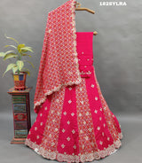A traditional wear lehenga set with bandhani print and white bead work