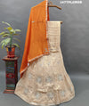 A traditional Indian lehenga with beige and orange colors.