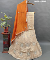 A traditional Indian lehenga with beige and orange colors.
