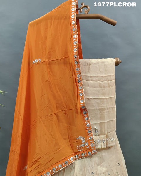 A traditional Indian lehenga with beige and orange colors.