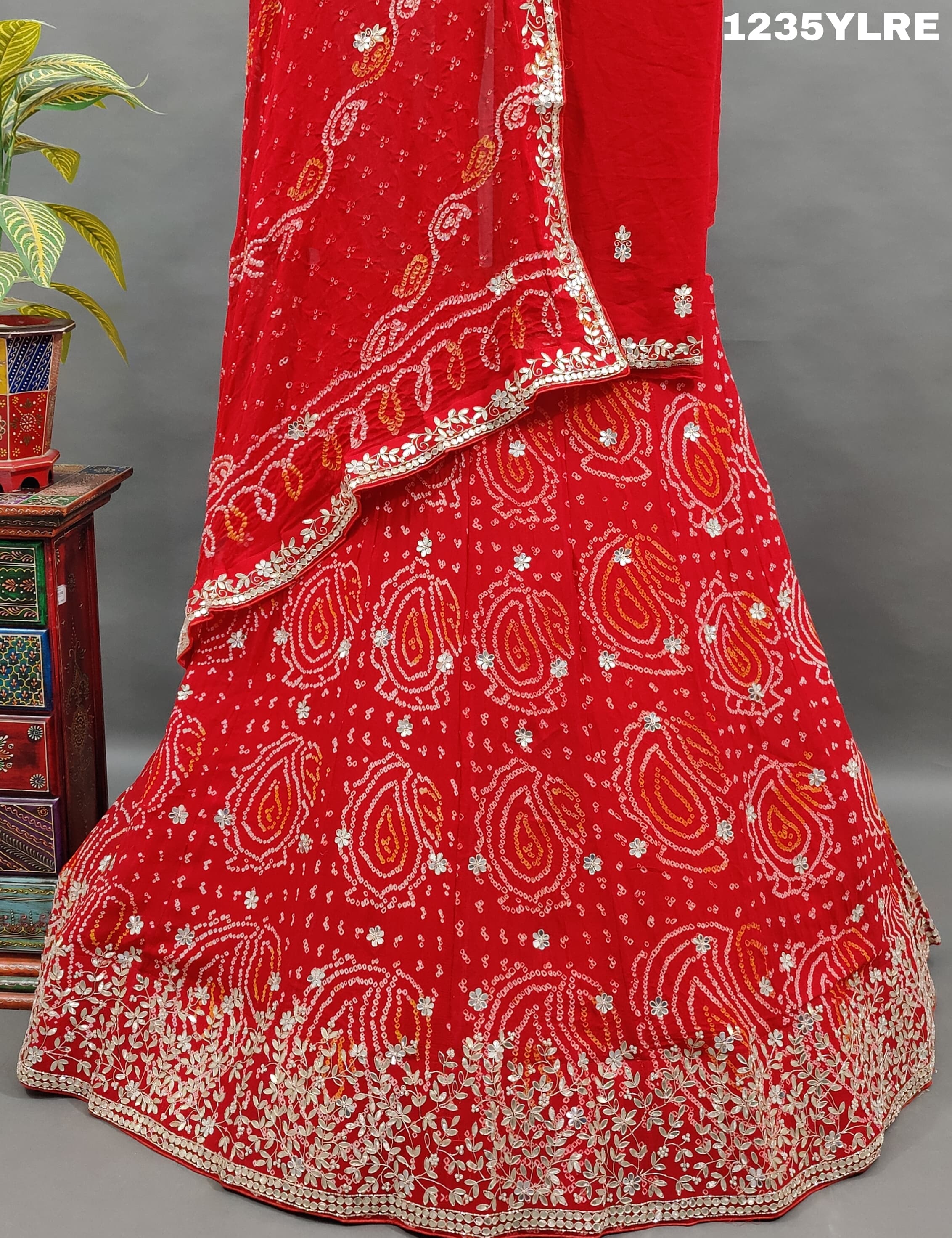 A red lehenga set with gota patti work 