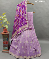 A traditional purple lehenga with Gatapati work 