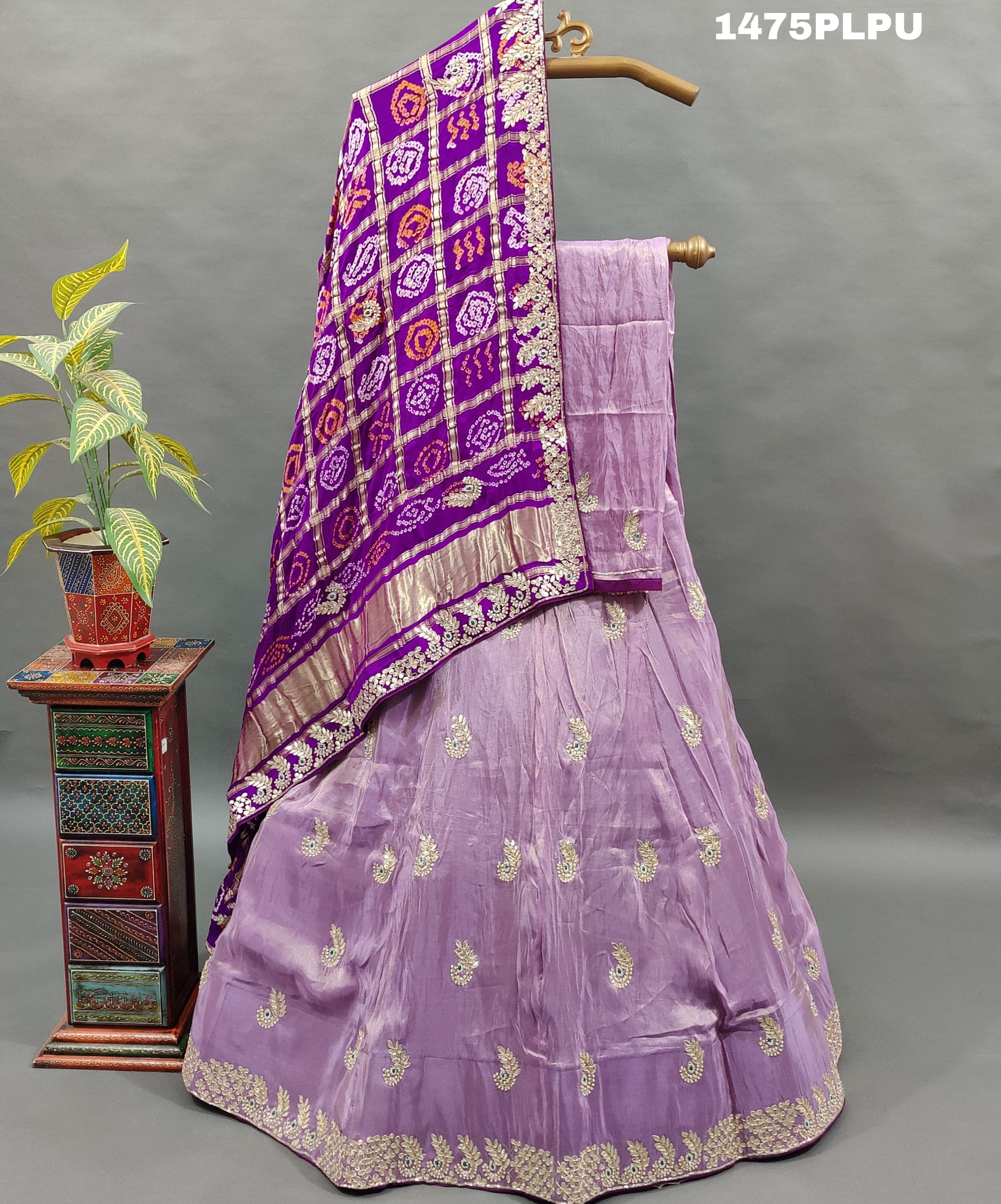 A traditional purple lehenga with Gatapati work 