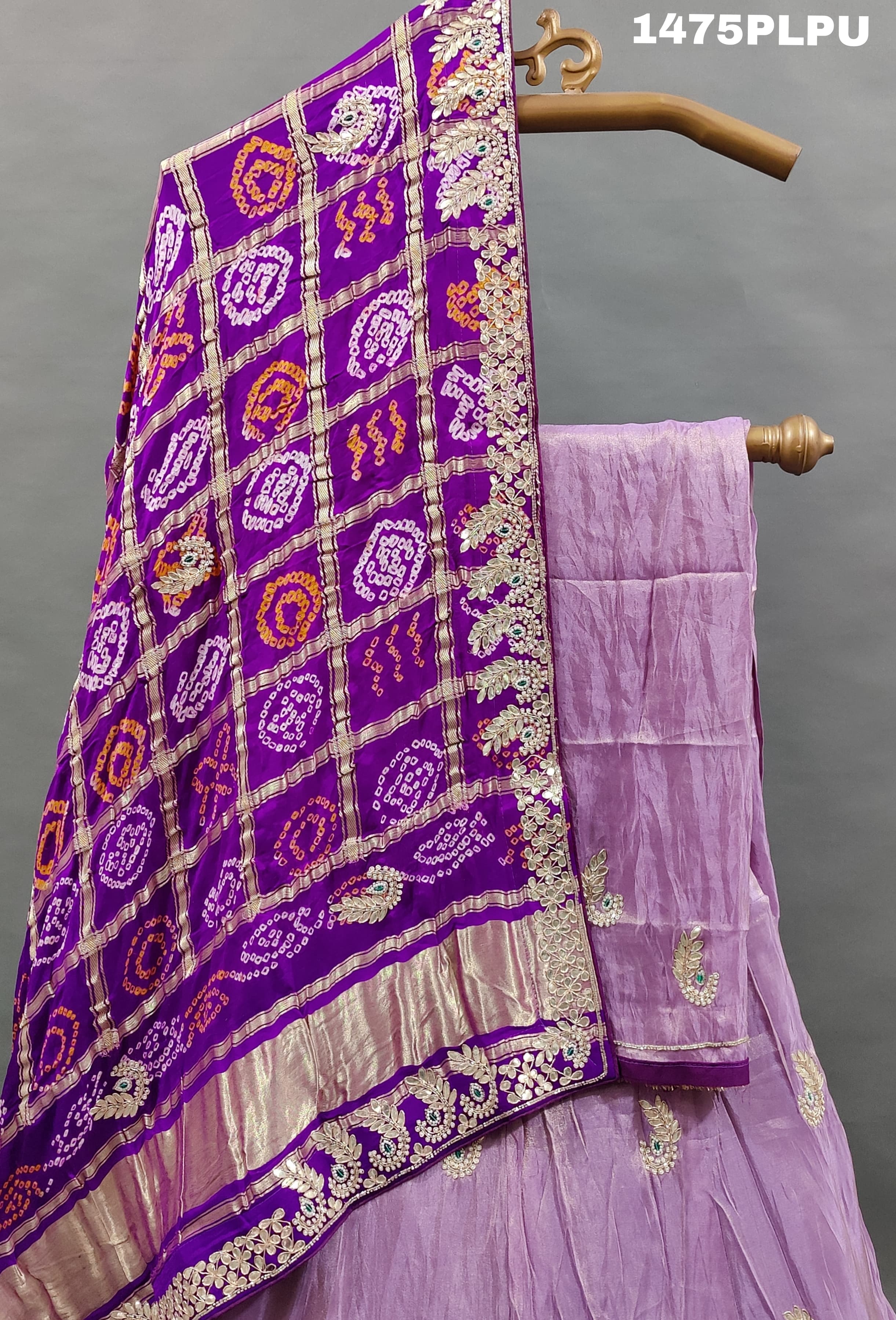 A traditional purple lehenga with Gatapati work 