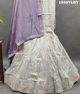 A traditional Indian lehenga set with white beadwork and a pastel pink Banarasi silk 