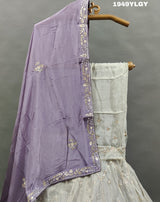 A traditional Indian lehenga set with white beadwork and a pastel pink Banarasi silk 