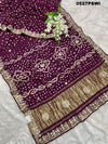 A purple modal silk bandhani saree with gota patti work and a floral embellishment 