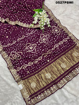 A purple modal silk bandhani saree with gota patti work and a floral embellishment 