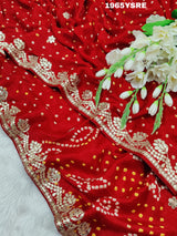 A red and gold modal silk saree with gota patti work