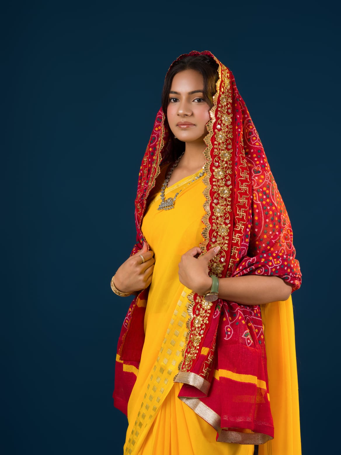 Ared and yellow traditional Marwadi chunri with floral and geometric patterns and a border.
