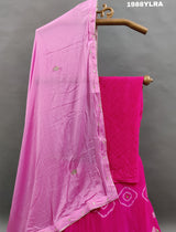A traditional wear lehenga set with pink and white color bandhani style