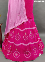 A traditional wear lehenga set with pink and white color bandhani style