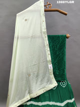 A green and white traditional wear lehenga set with tie-dye bandhani 
