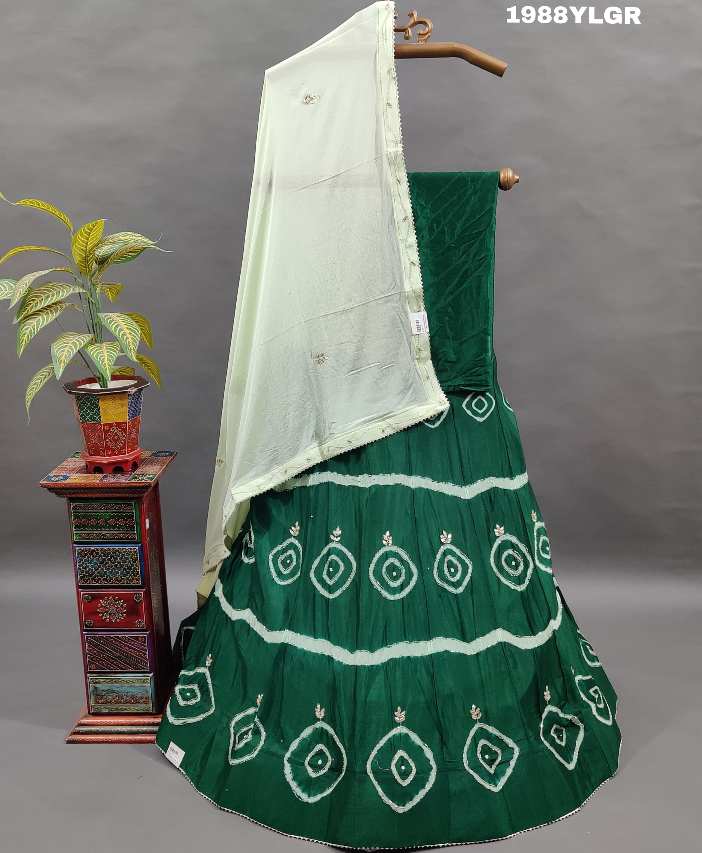 A green and white traditional wear lehenga set with tie-dye bandhani 