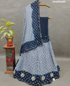A lehenga set with a blue and gray colordouble shade Bandhani cutdana work
