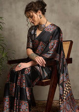 A black saree with red and blue floral ajrak print