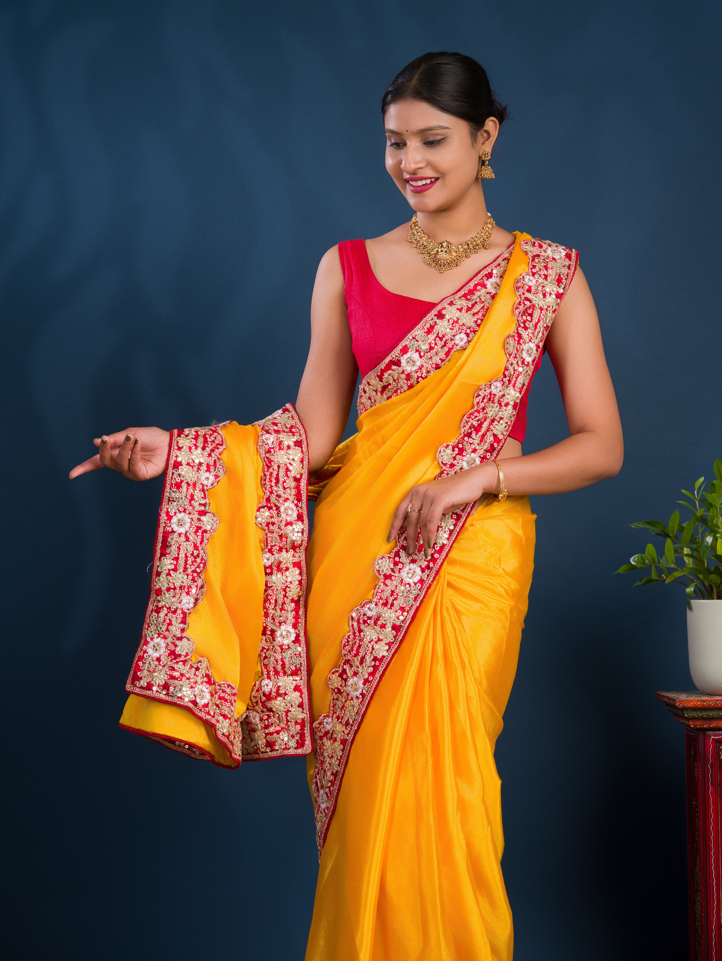 A yellow saree with red borderChinon Silk Bollywood Style With Sequence Gotapatti Work Saree 