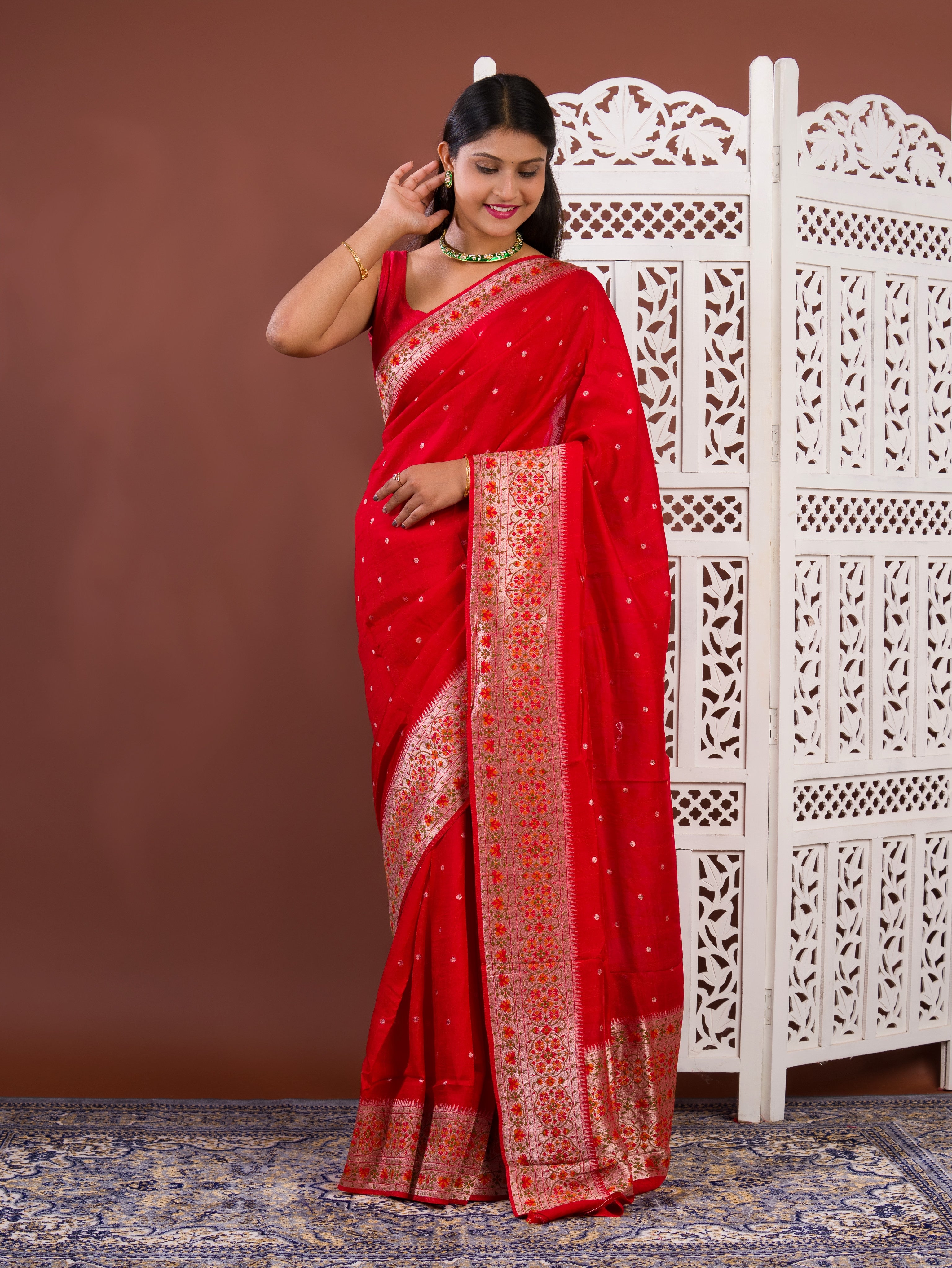 A red saree with white patternsBanarasi Zari Weaving Saree