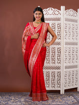 A red saree with white patternsBanarasi Zari Weaving Saree