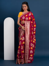 A maroon saree with gold patterns withDola Silk Bandhani Zari Weaving Work 