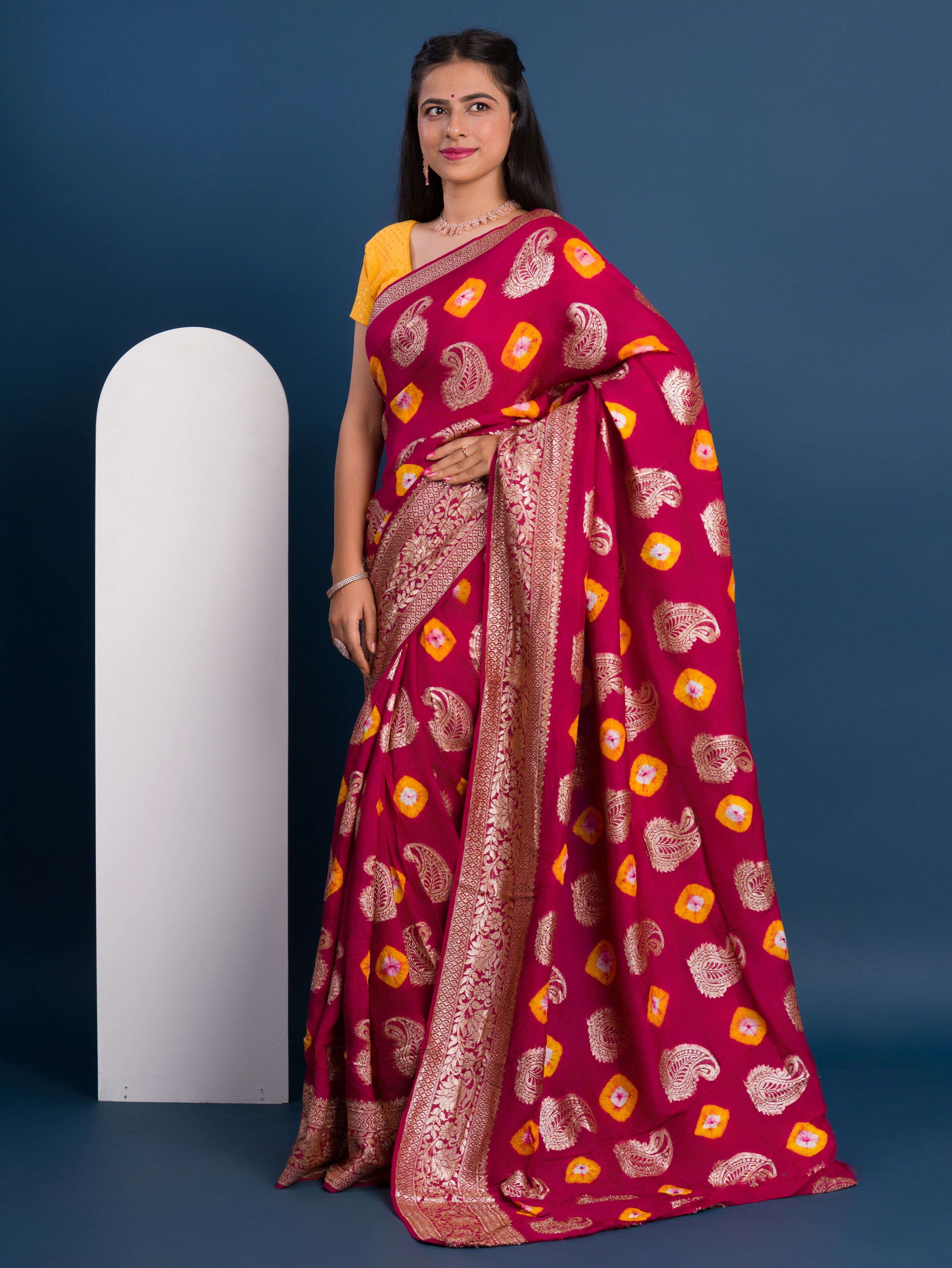 A maroon saree with gold patterns withDola Silk Bandhani Zari Weaving Work 