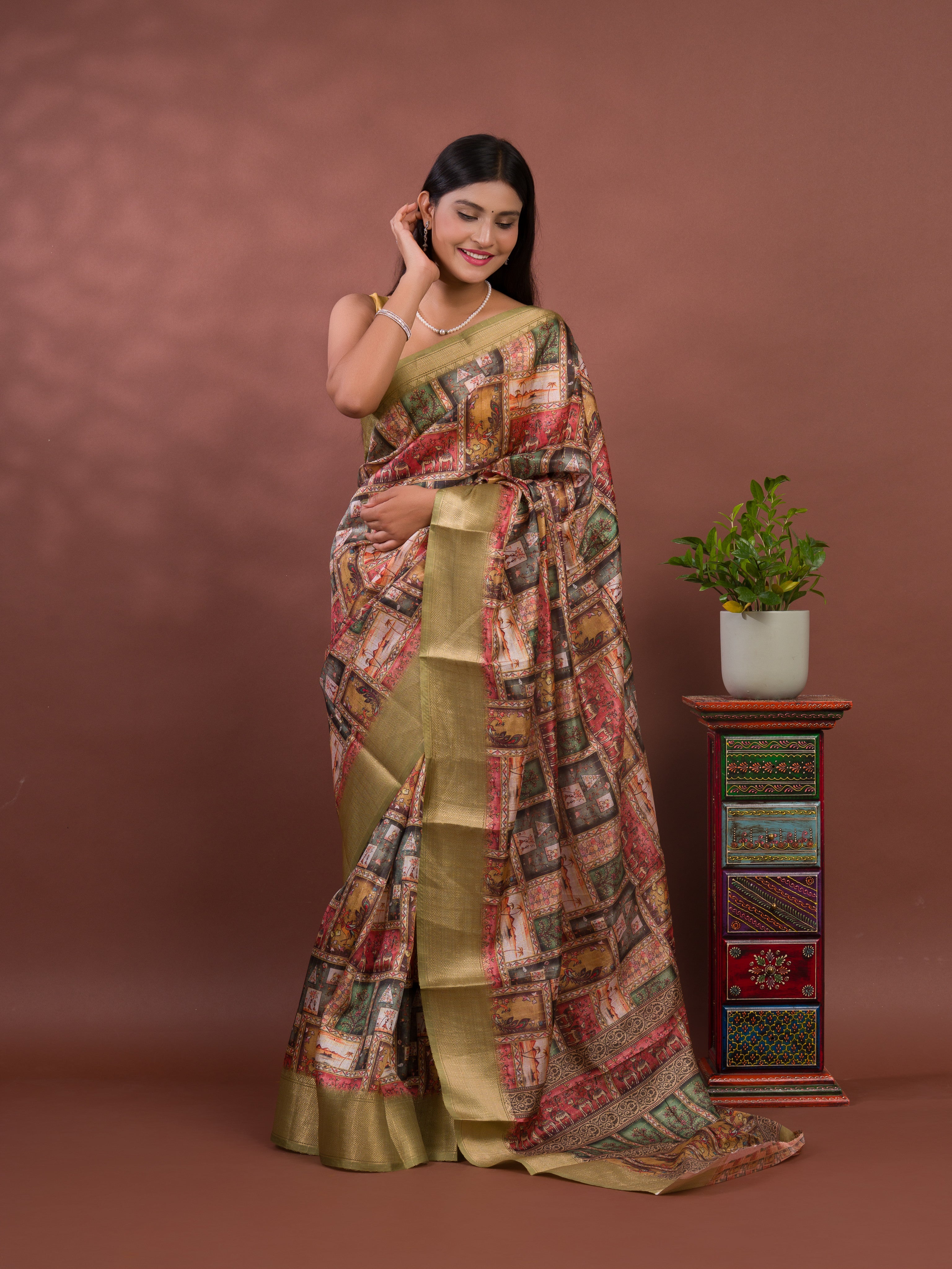 A saree with a kalamkari style pattern in green colors, with zari weaving and a Banarasi border. under 1000