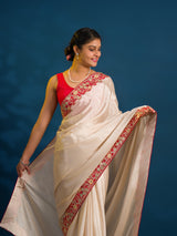 A white chinon silk Bollywood style saree with embellishments and gotapatti work