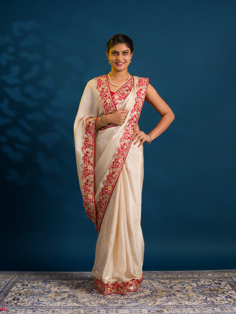 A white chinon silk Bollywood style saree with embellishments and gotapatti work