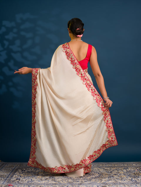 A white chinon silk Bollywood style saree with embellishments and gotapatti work