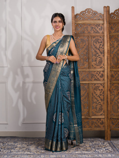 A blue saree with bandhani style embellishments and zari work