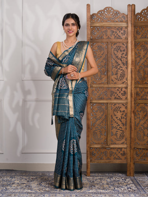 A blue saree with bandhani style embellishments and zari work