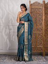 A blue saree with bandhani style embellishments and zari work