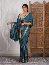 A blue saree with bandhani style embellishments and zari work