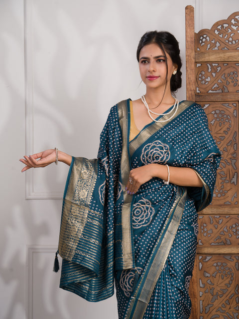 A blue saree with bandhani style embellishments and zari work