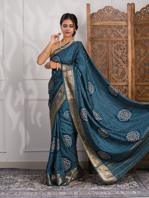 A blue saree with bandhani style embellishments and zari work
