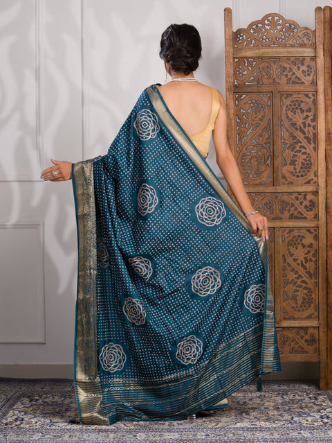 A blue saree with bandhani style embellishments and zari work