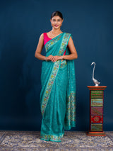 A teal saree with floral patternsBanarasi Silk Printed Style With zari weaving Work Saree 