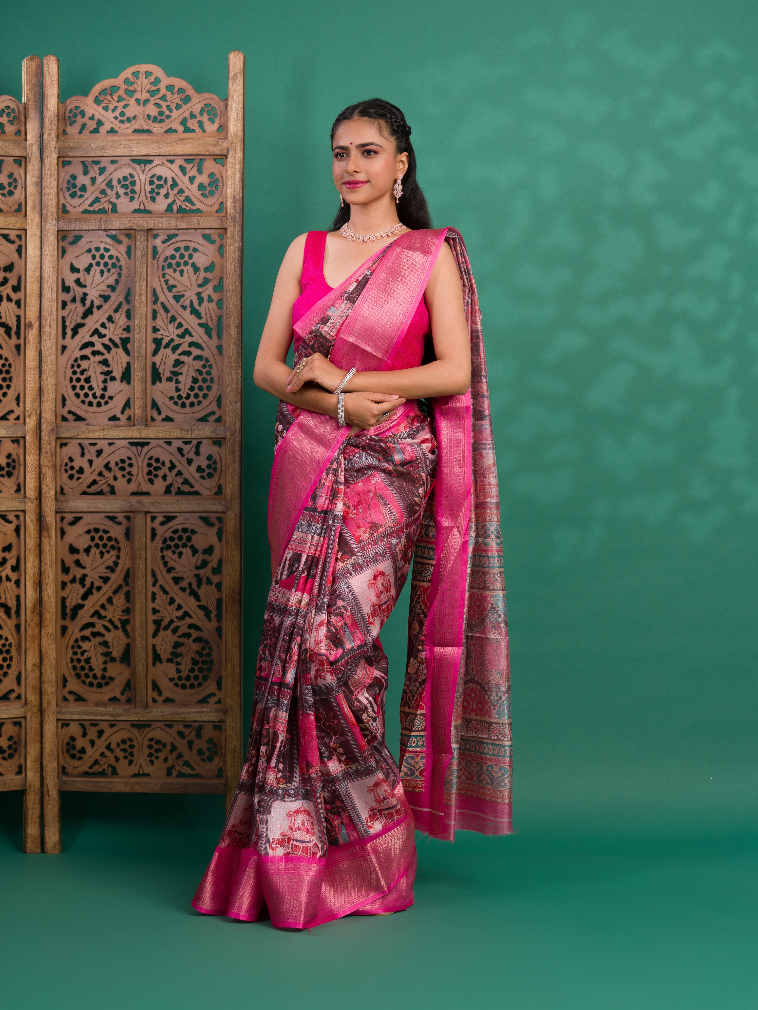 A saree with a kalamkari style pattern in pink colors, with zari weaving and a Banarasi border.