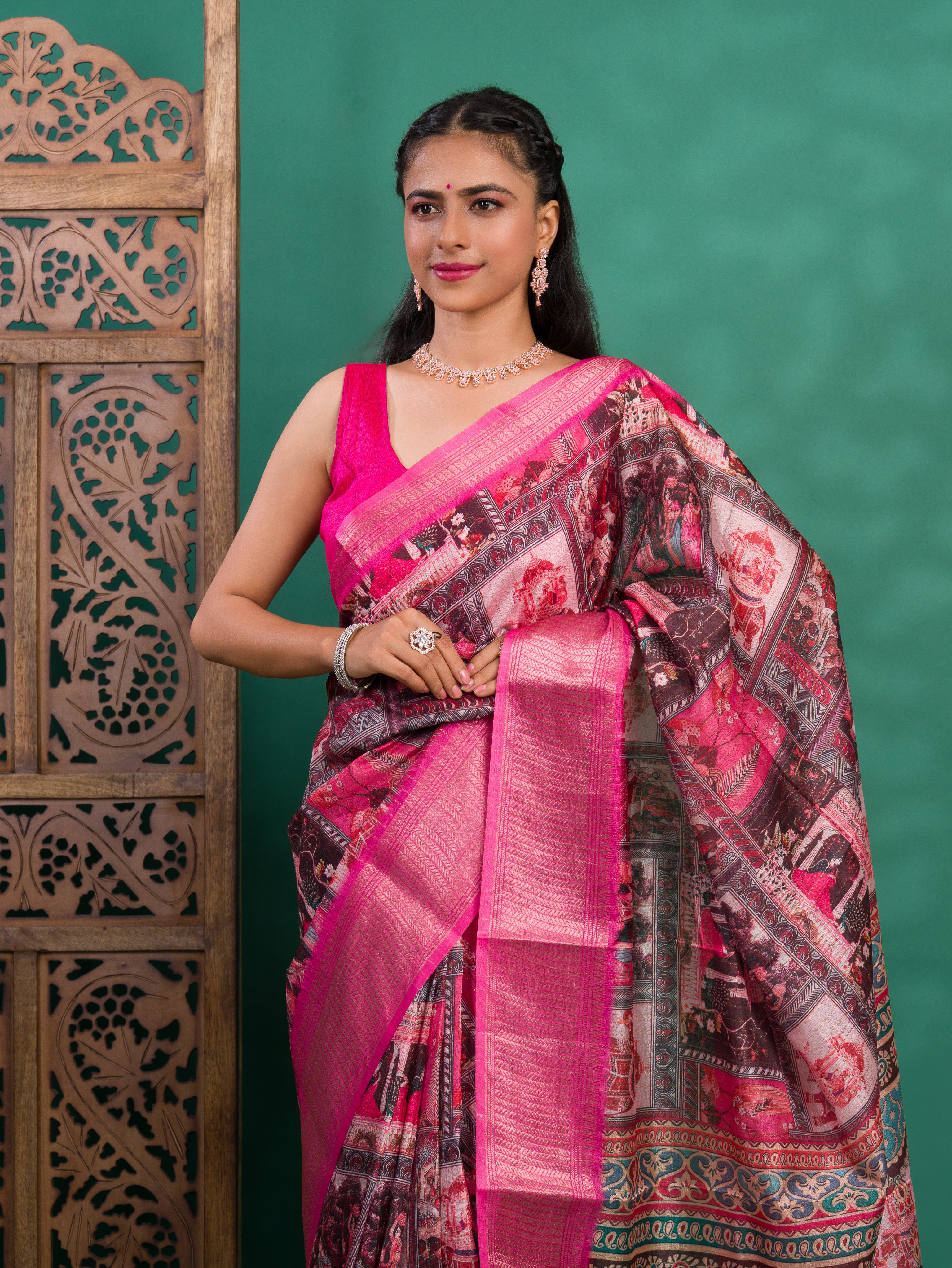 A saree with a kalamkari style pattern in pink colors, with zari weaving and a Banarasi border.